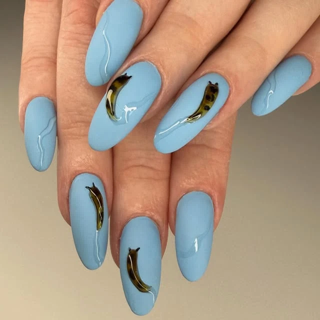 Pale blue almond nails with gold accents